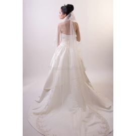 Un abito da sposa senza spalline con strass e velo